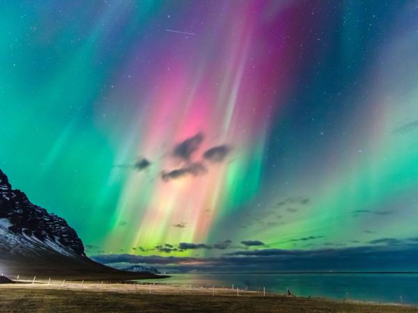 Incredible Northern Lights above a beach in Iceland