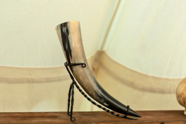 a horn is sitting on top of a wooden table .