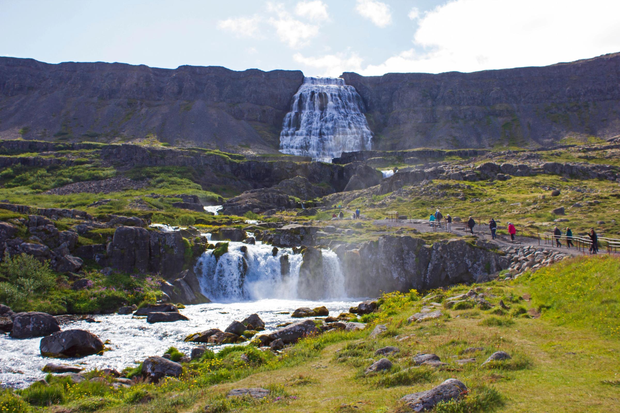 Dynjandi Waterfall with people visiting on a sunny day