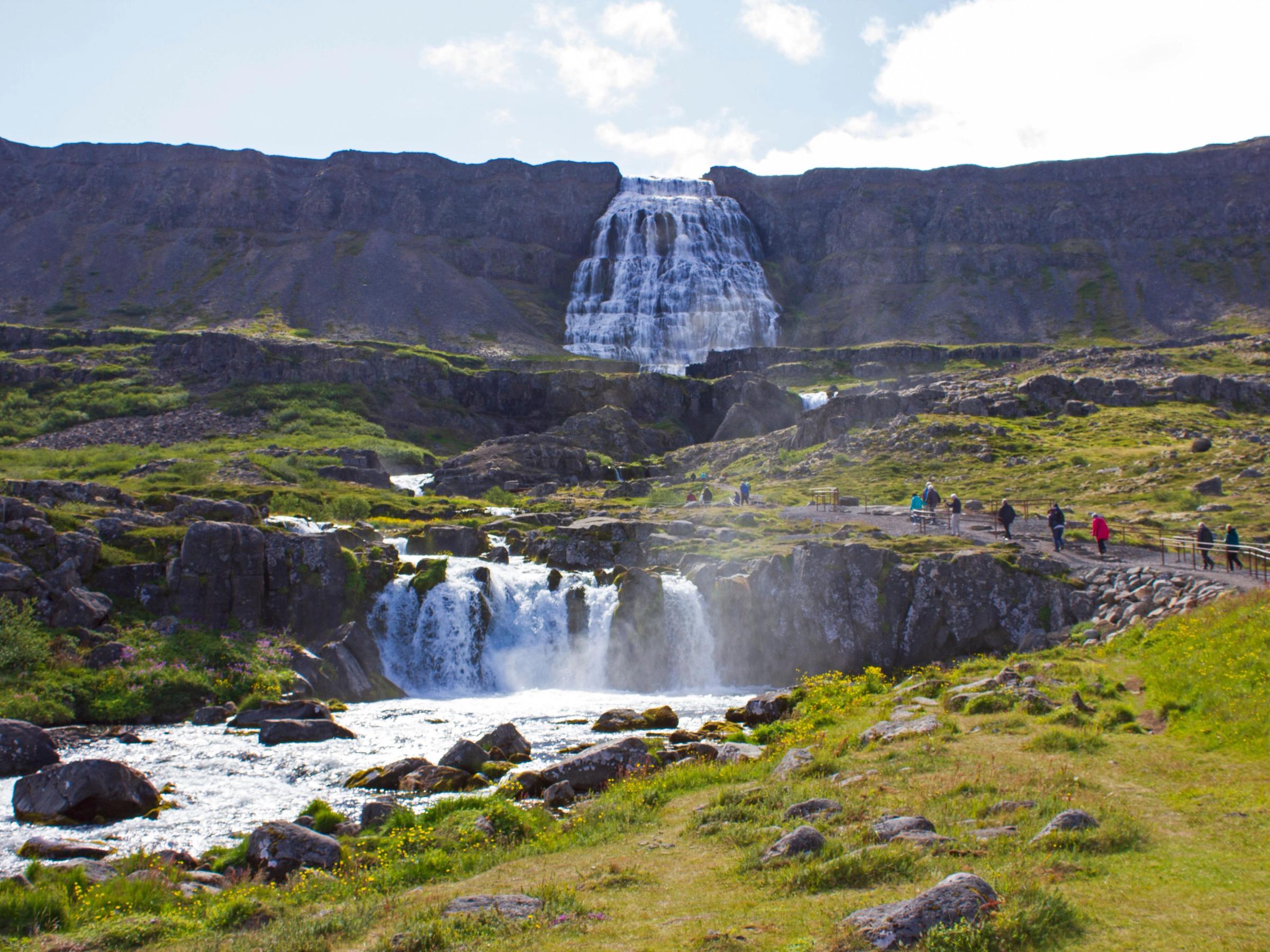 Dynjandi Waterfall with people visiting on a sunny day
