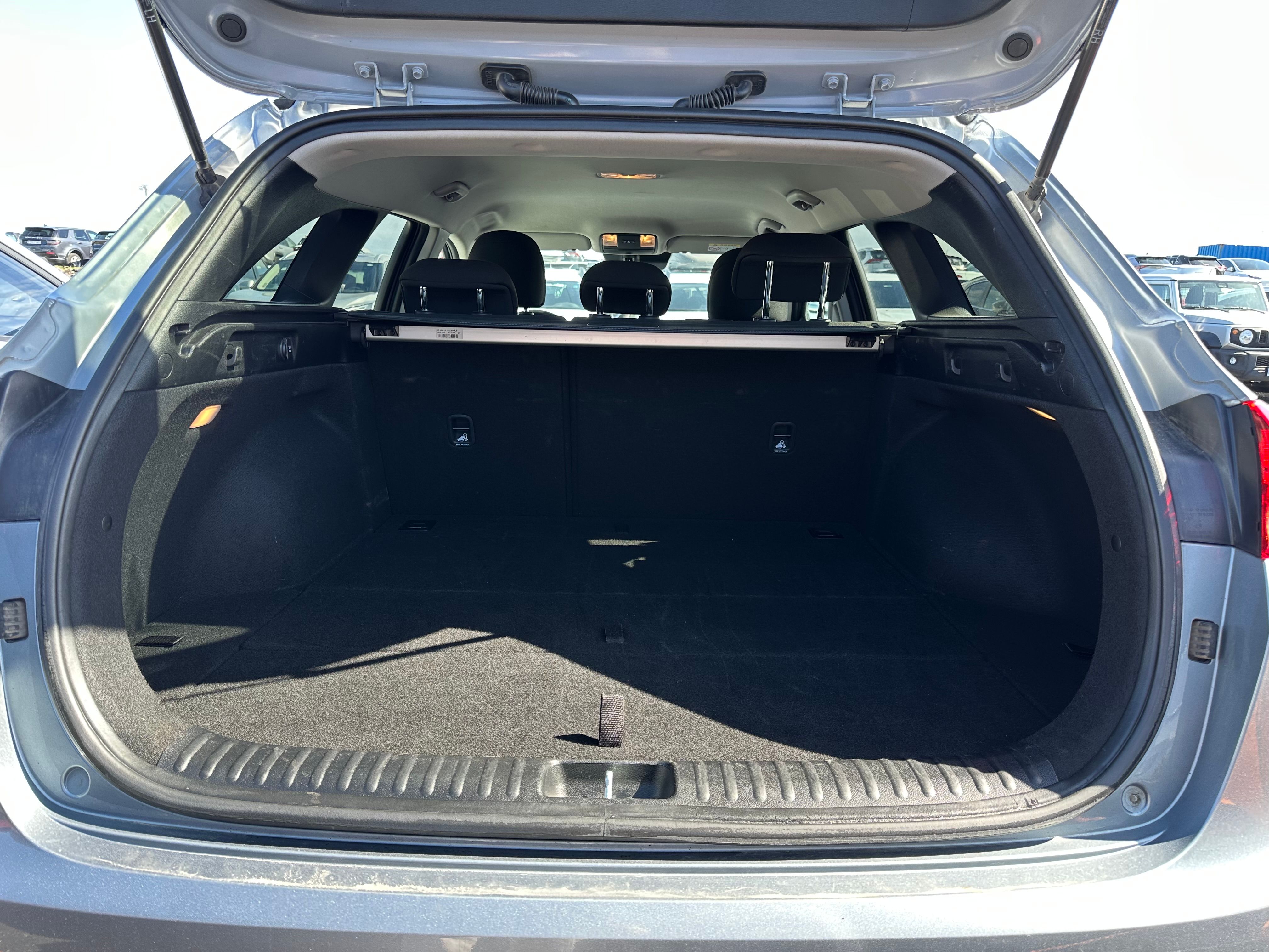 Open and empty cargo area of a gray hatchback.