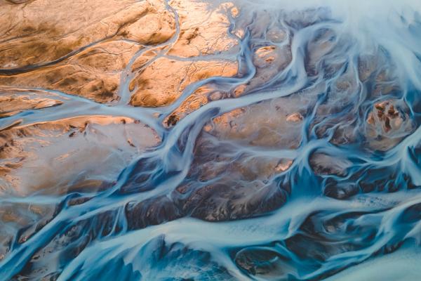 an aerial view of a river flowing through a rocky landscape in iceland.