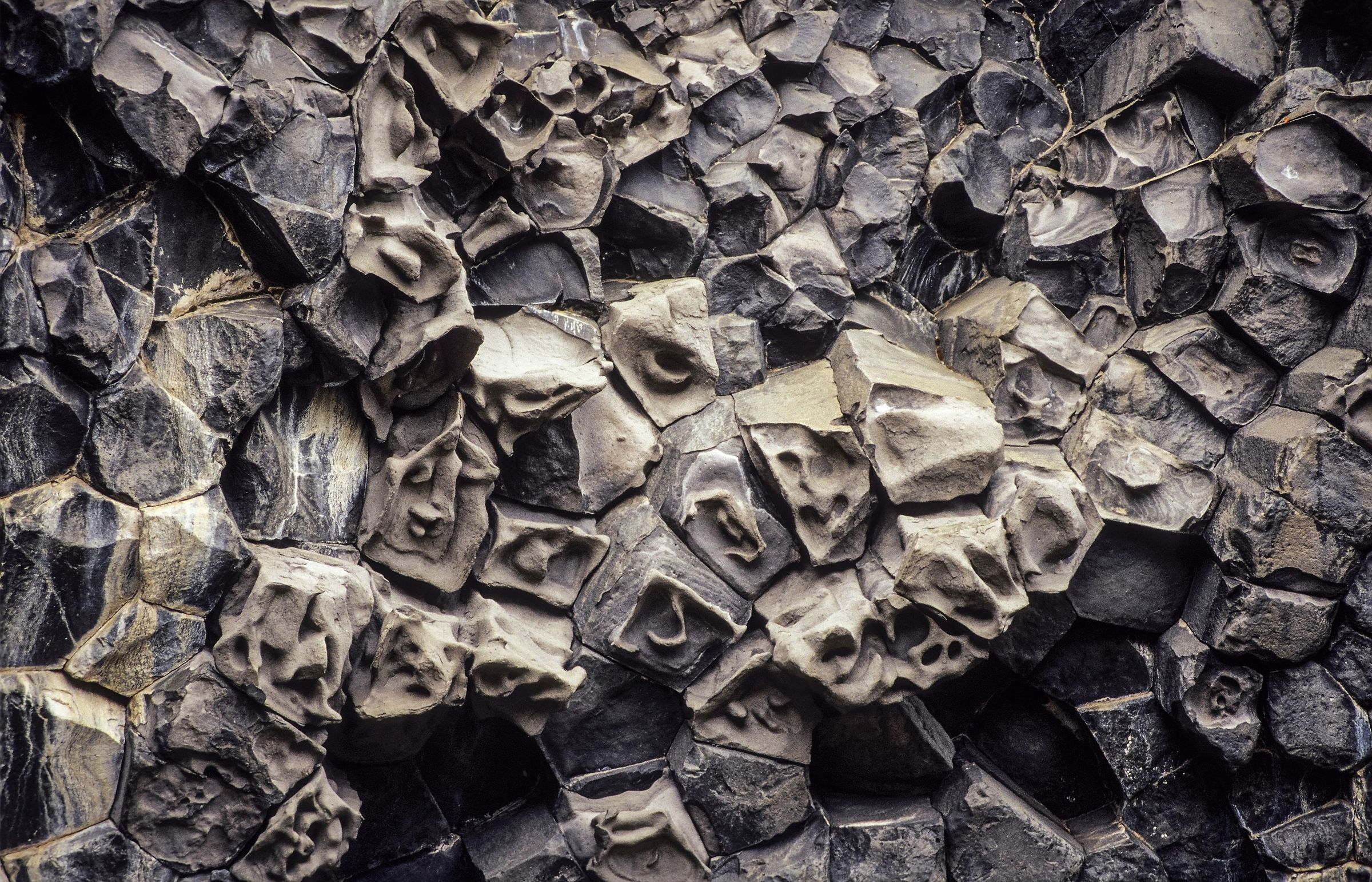 Dark gray basalt columns with weathered textures.