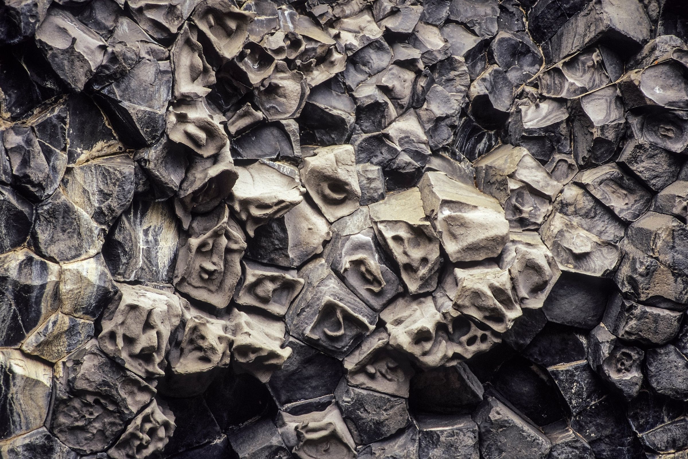 Dark gray basalt columns with weathered textures.