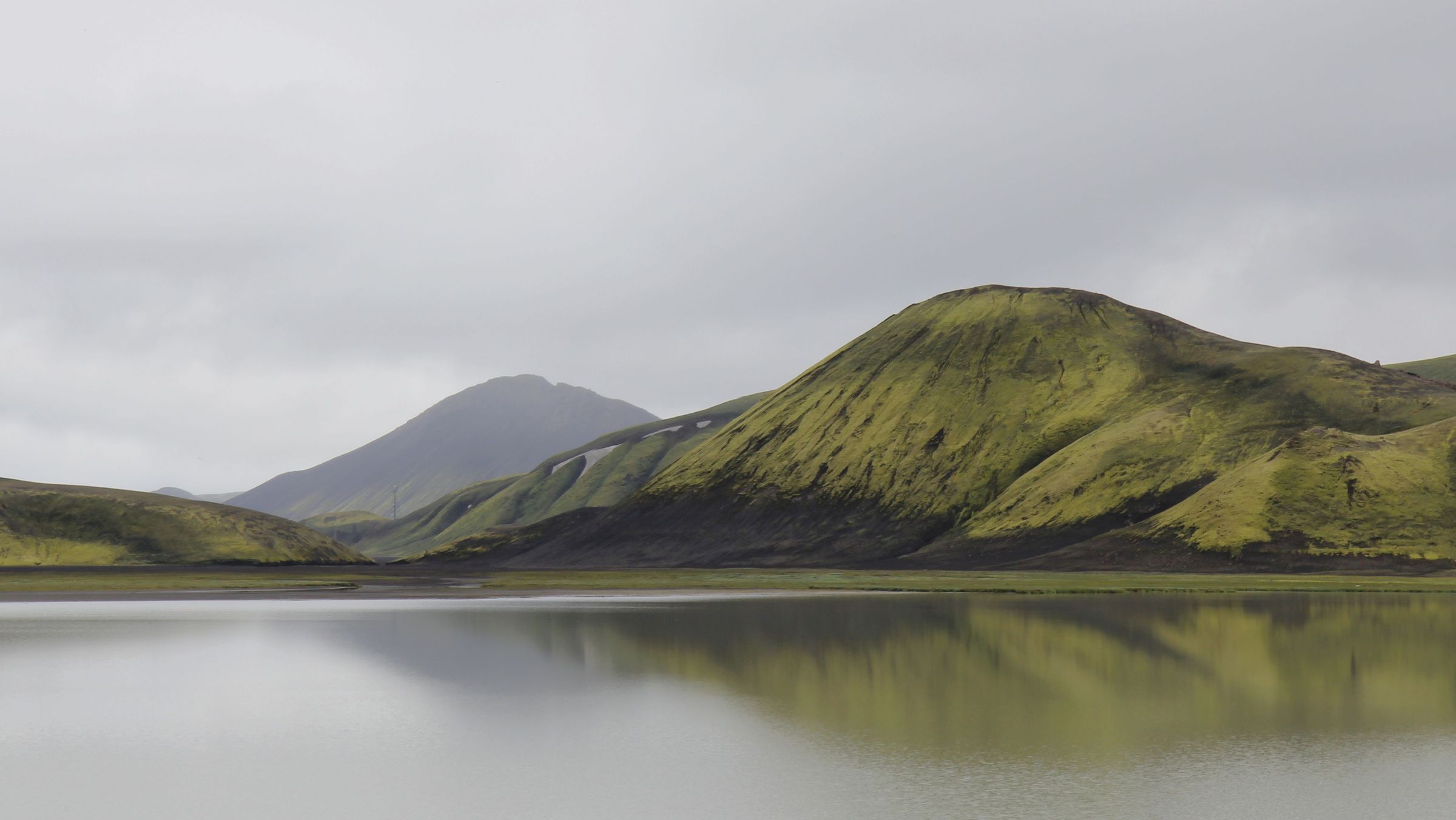 a lake with mountains in the background and a mountain reflected in the water .