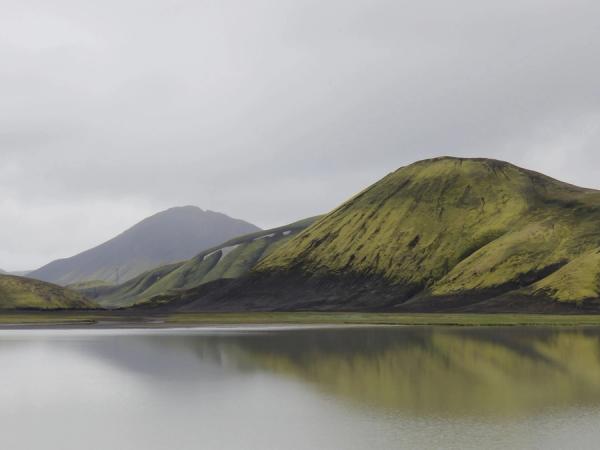 a lake with mountains in the background and a mountain reflected in the water .