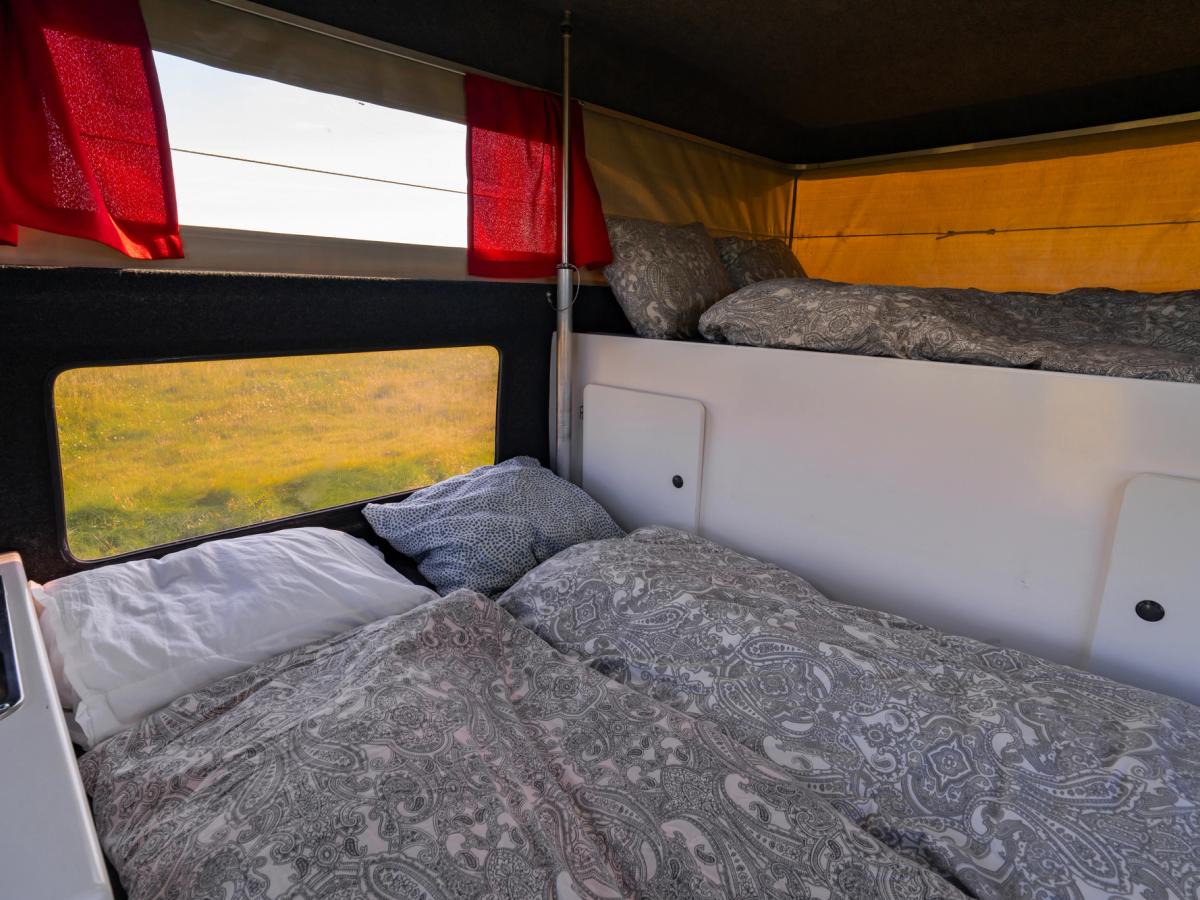 Lower And Upper Beds Lower bed with duvets below the over-cab bed, sleeping space for 4 in total