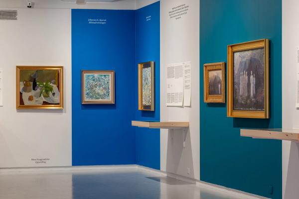 a museum with a lot of paintings on the walls .