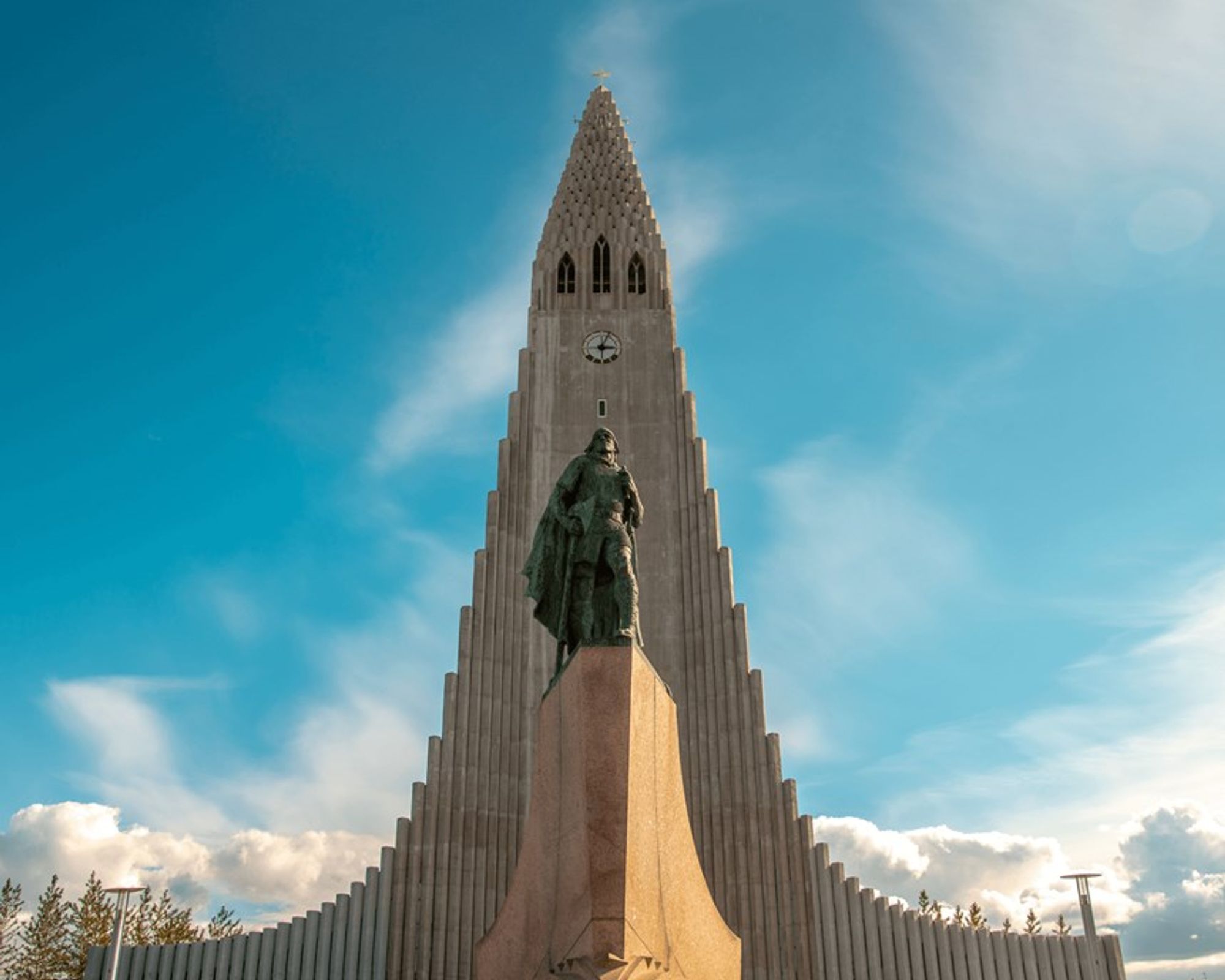 a large building with a statue in front of it in reykjavik, iceland.