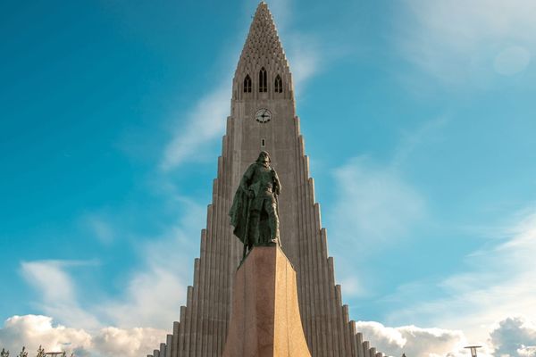 a large building with a statue in front of it in reykjavik, iceland.