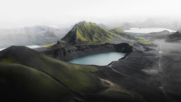 an aerial view of a lake in the middle of a mountain, Icelandic Highlands