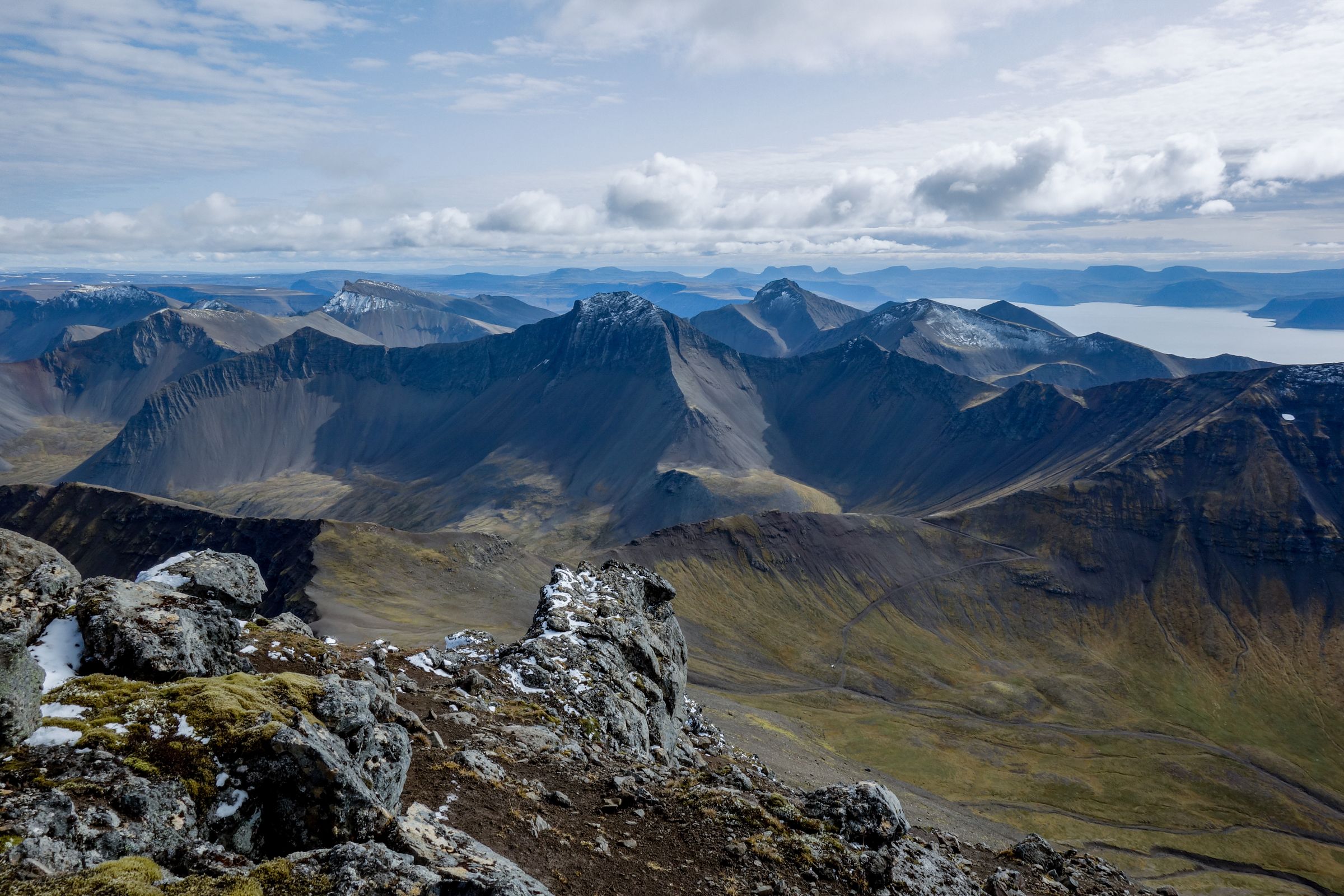 a view of a mountain range from the top of a mountain .