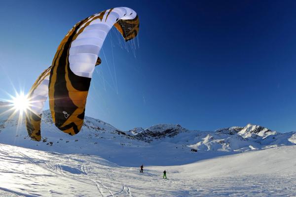 Two people snowkiting