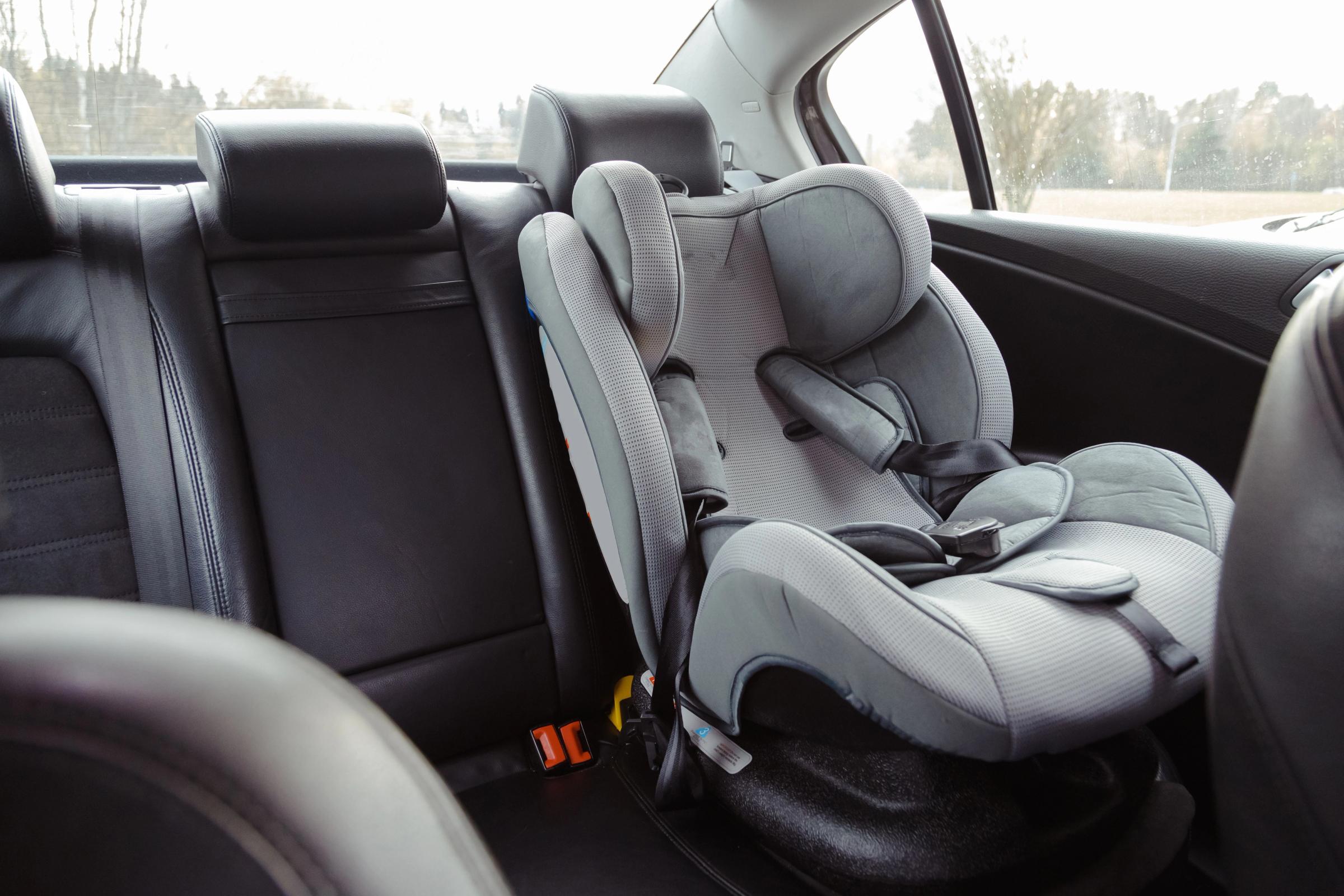 Booster seat placed in the backseat of a rental car in Iceland.