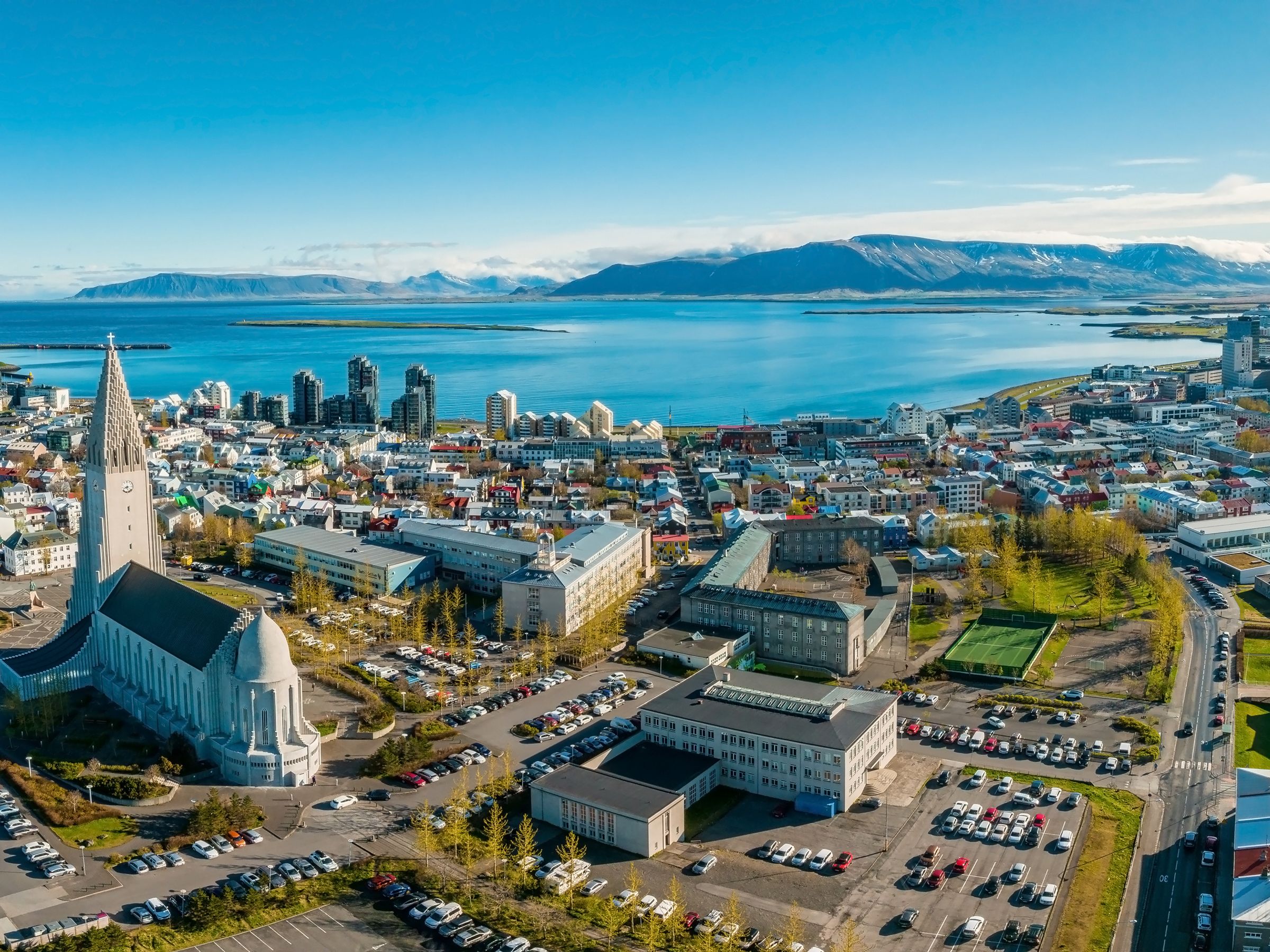 coastal city with a big church and mountains on the background
