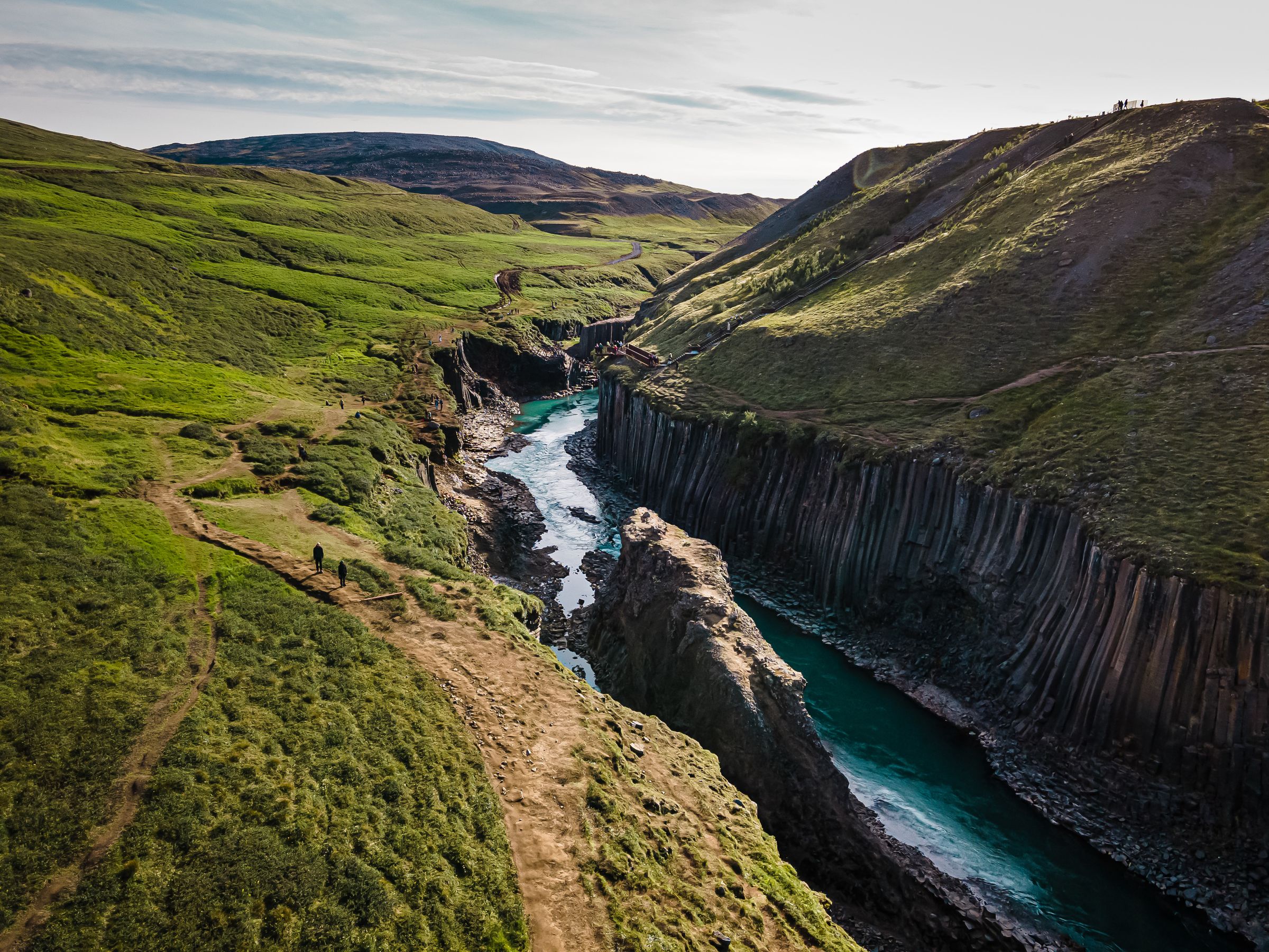 an aerial view of a river flowing through a canyon between two mountains .