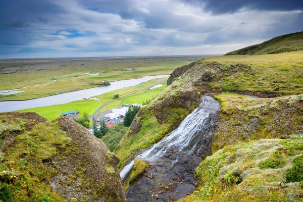 Little village seen from a cliff with a waterfall