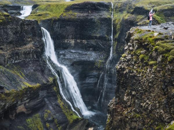 Granni Waterfall with a girl taking a selfie from the viewpoint