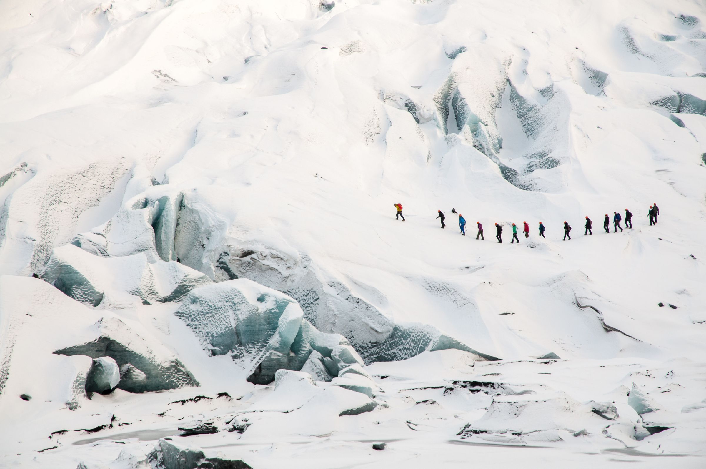 a group of people hiking a glacier