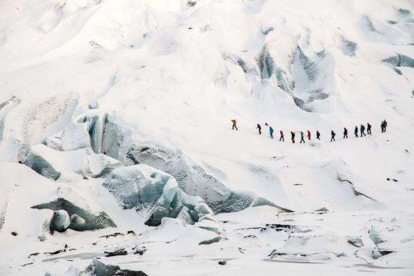 a group of people hiking a glacier