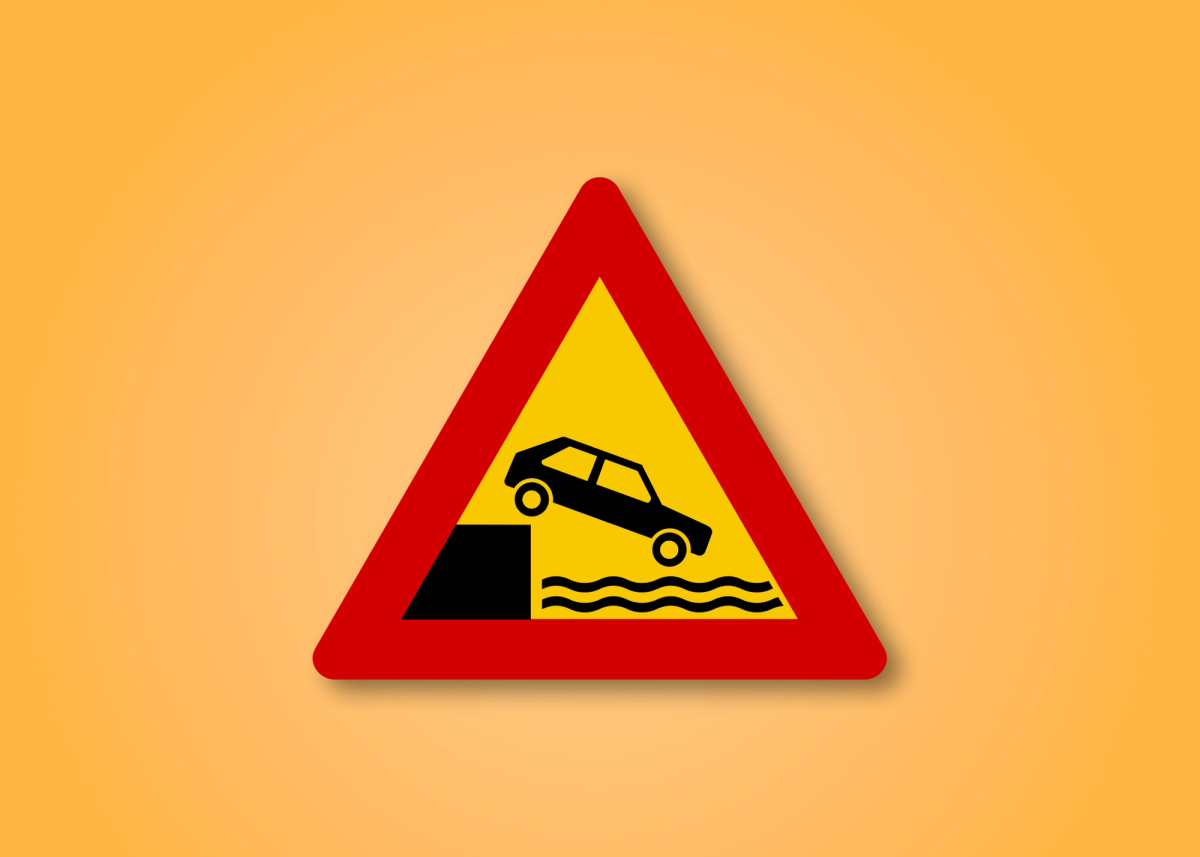 a yellow and red sign with a car on it