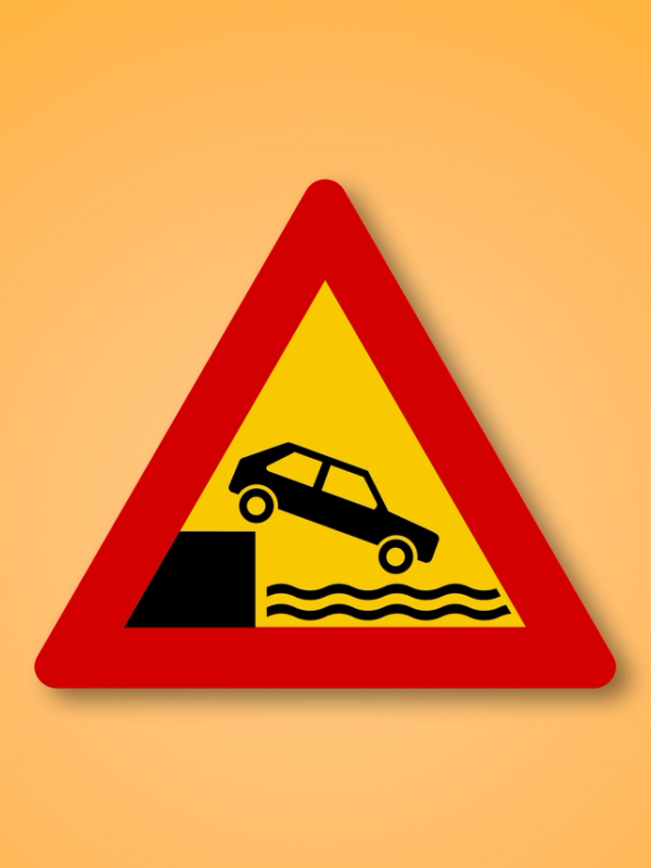 a yellow and red sign with a car on it