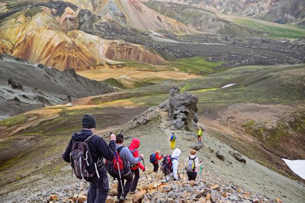 a group of people are hiking up a rocky mountain, Laugavegur trail Iceland
