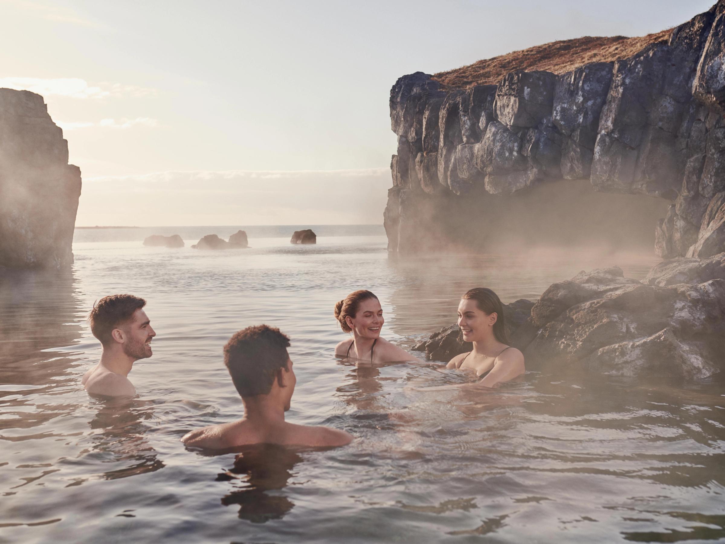 Hot springs in iceland: Sky Lagoon, a Geothermal pool with warm waters in Reykjavik Iceland, the perfect place to see midnight sun.