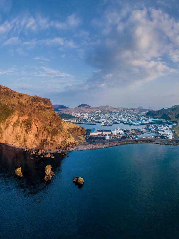 an aerial view of a the Westman islands in the middle of the ocean at sunset.
