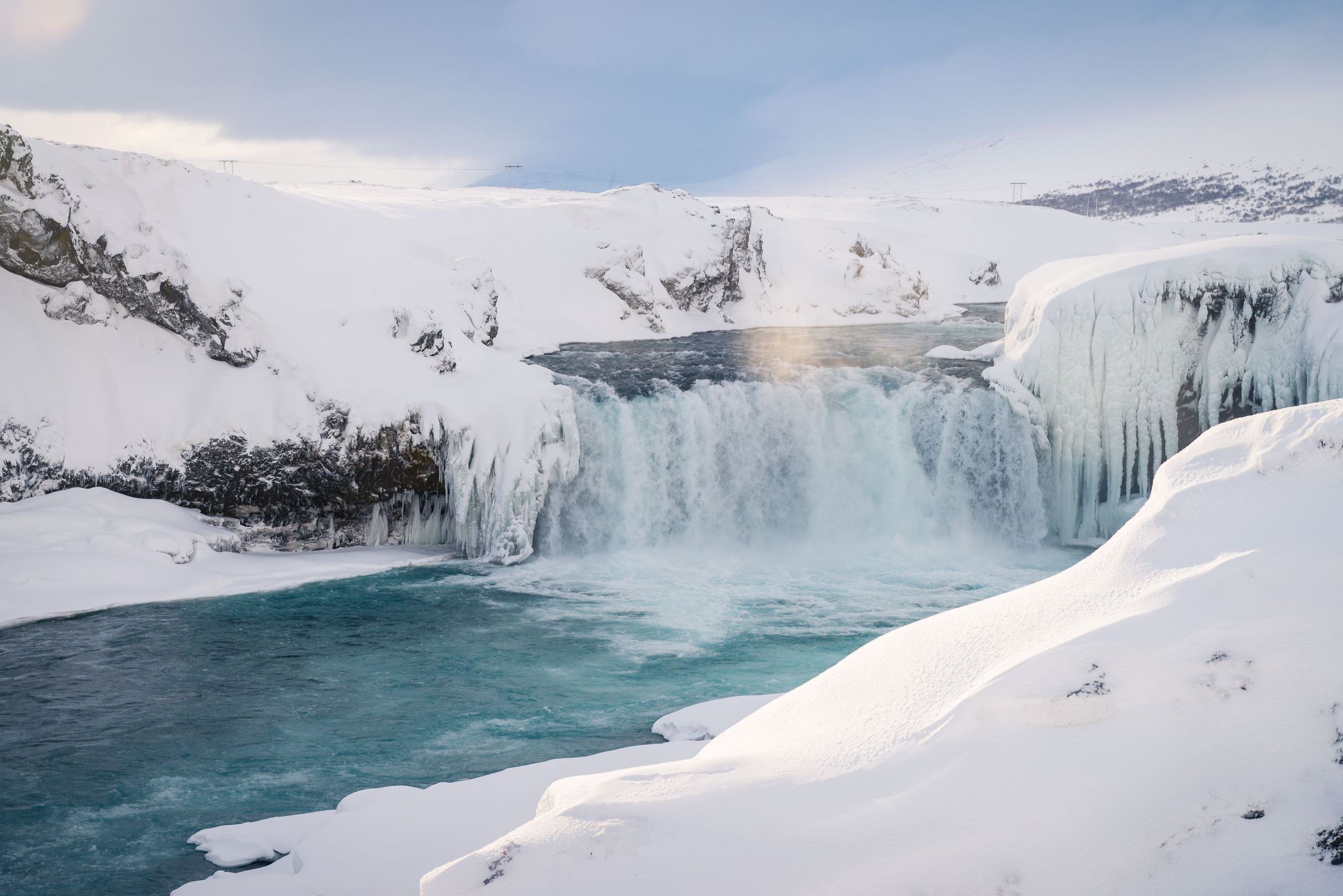 A picture of godafoss waterfall with snow during a warm day. Amazing experience for anyone coming to iceland.