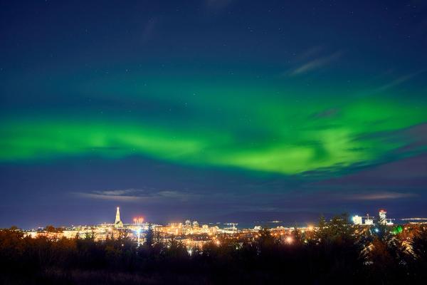 The Northern Lights dancing above a city