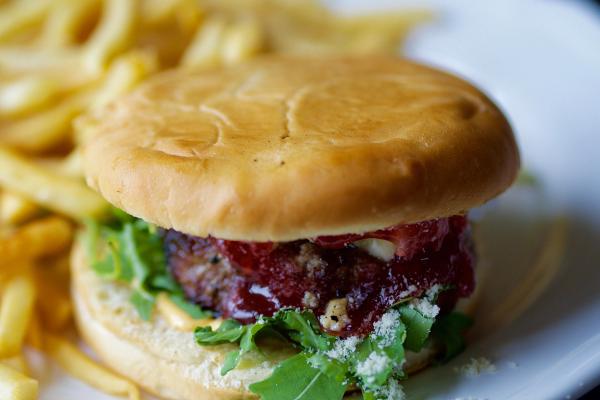 a hamburger and french fries on a white plate.