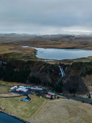 an aerial view of a river flowing through a valley in iceland .