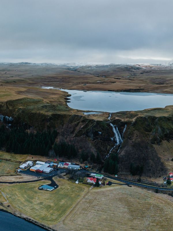 an aerial view of a river flowing through a valley in iceland .