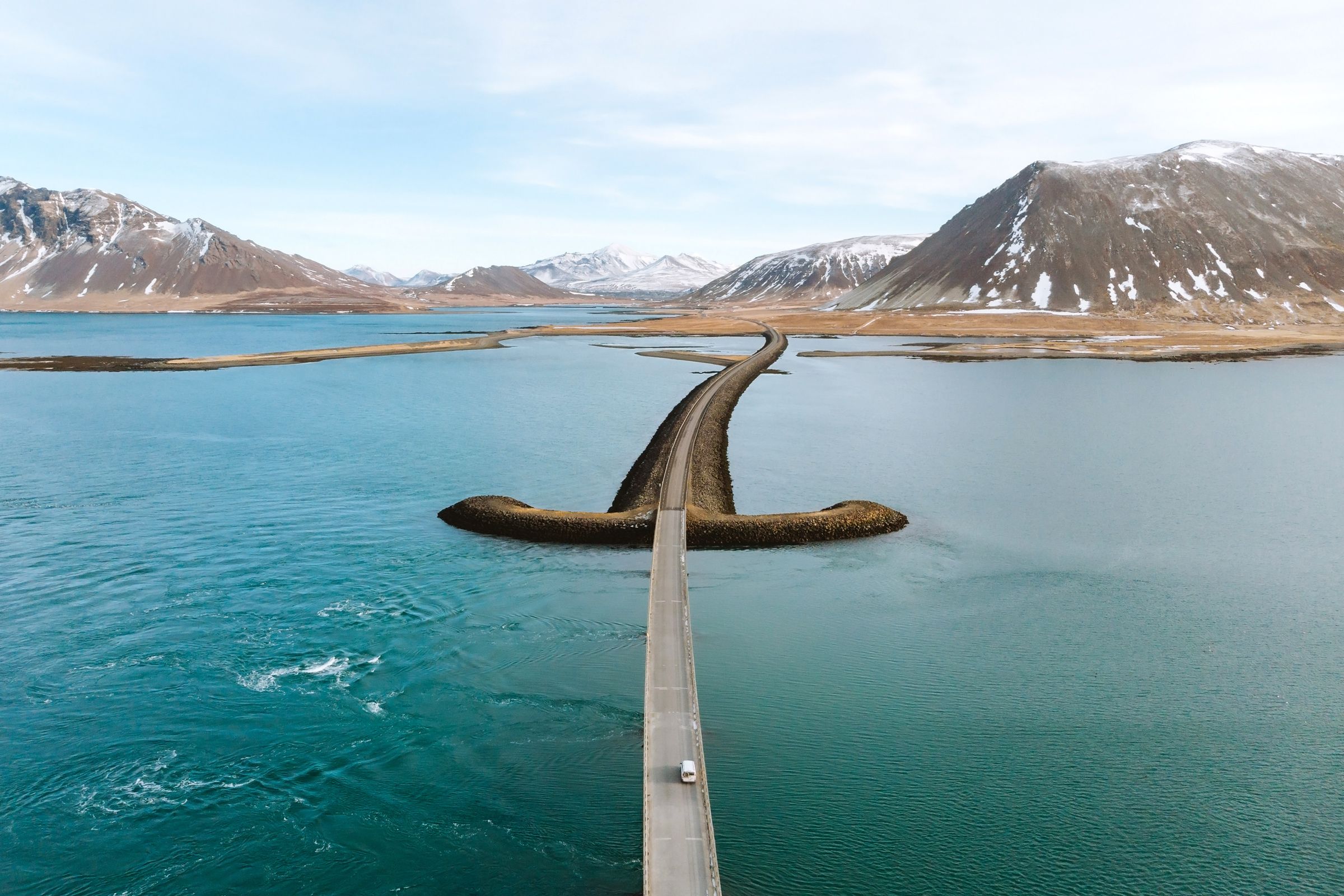 an aerial view of a bridge over a body of water .