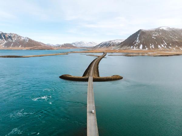 an aerial view of a bridge over a body of water .
