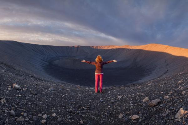 Panoramic of Hverfjall Volcano with a girl stretching her arms