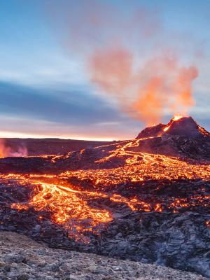 a volcano is erupting with lava coming out of it at Fagradalsfjall in iceland.