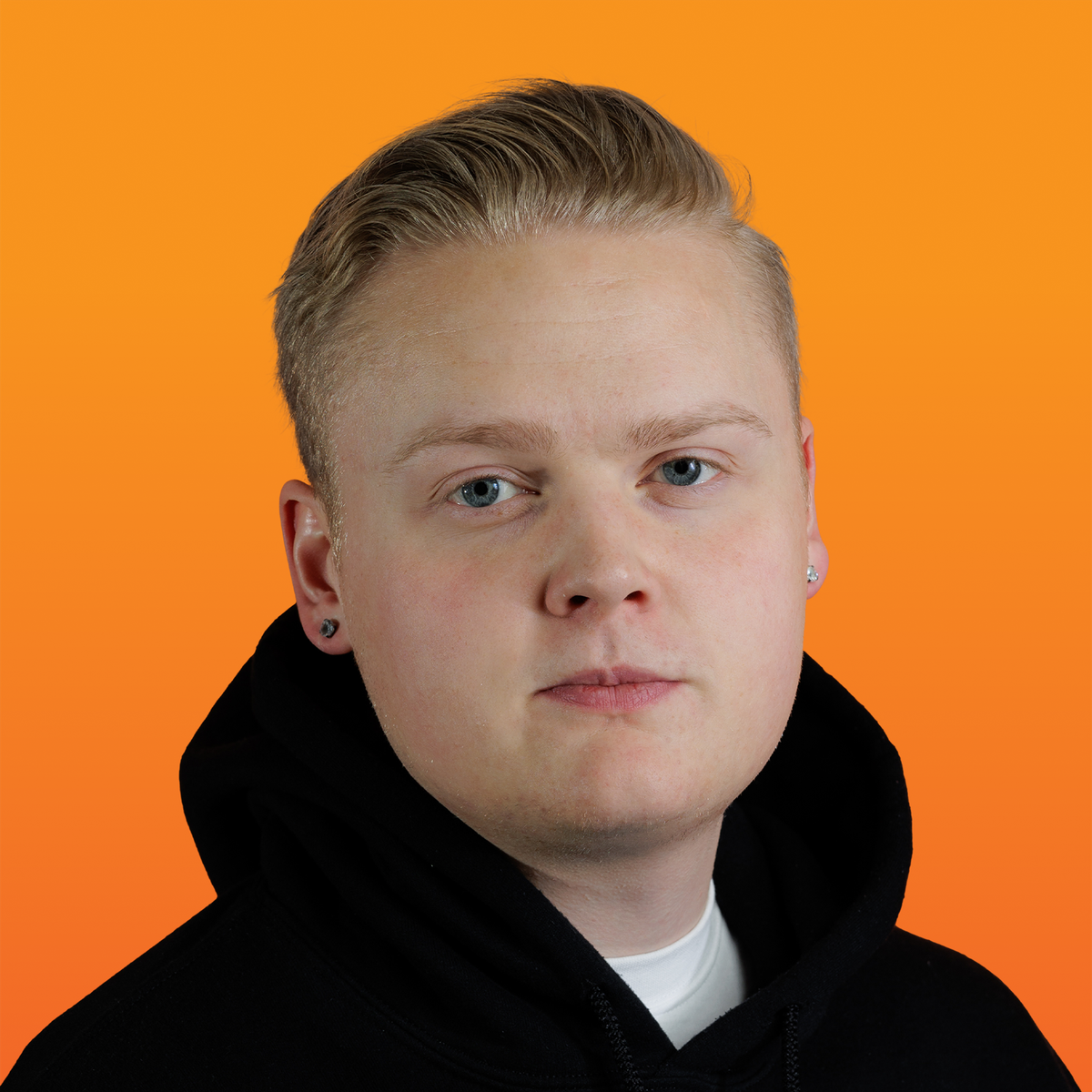 a young man wearing a black hoodie looks at the camera
