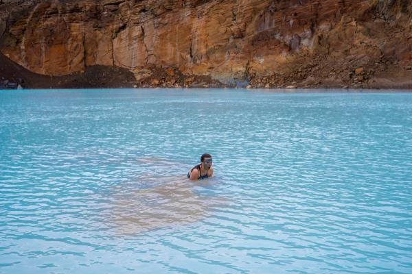 Girl swimming on a volcanic crater