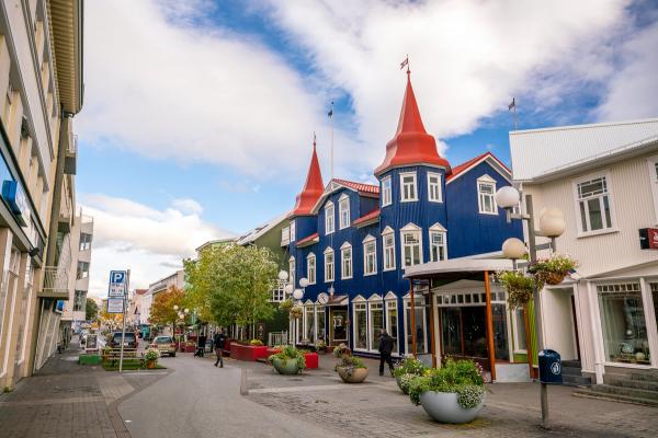 a street with a traditional blue wood house
