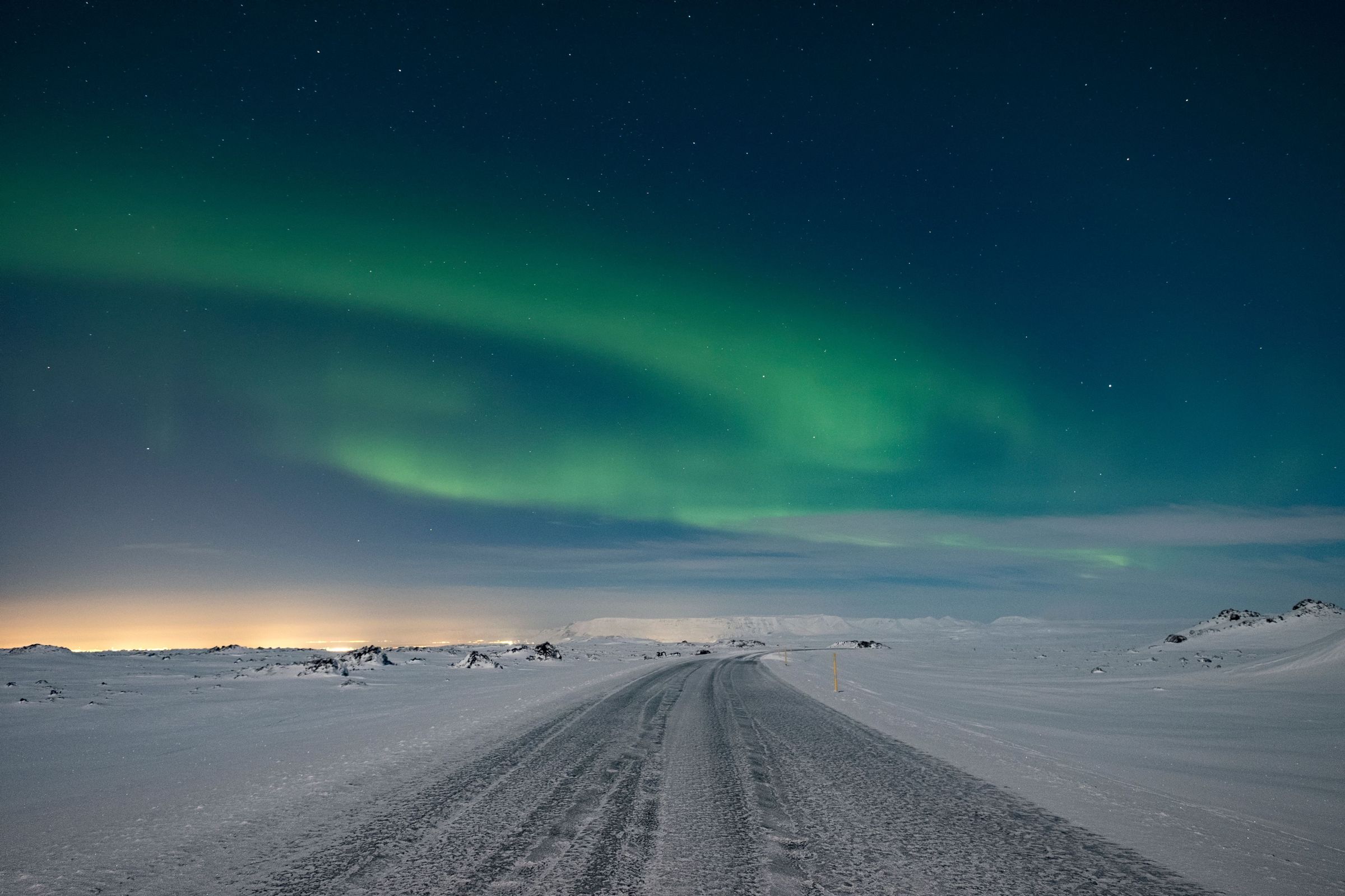 road in iceland Expect snow while driving the ring road with northern lights dancing in the sky