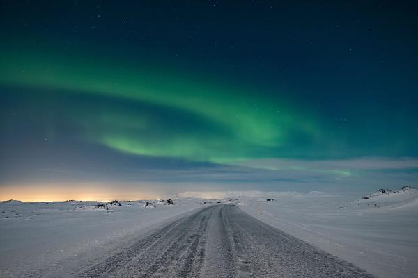 road in iceland Expect snow while driving the ring road with northern lights dancing in the sky