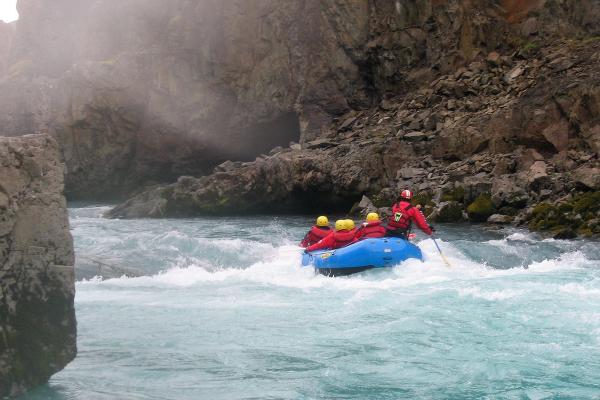 Group of people river rafting in Iceland