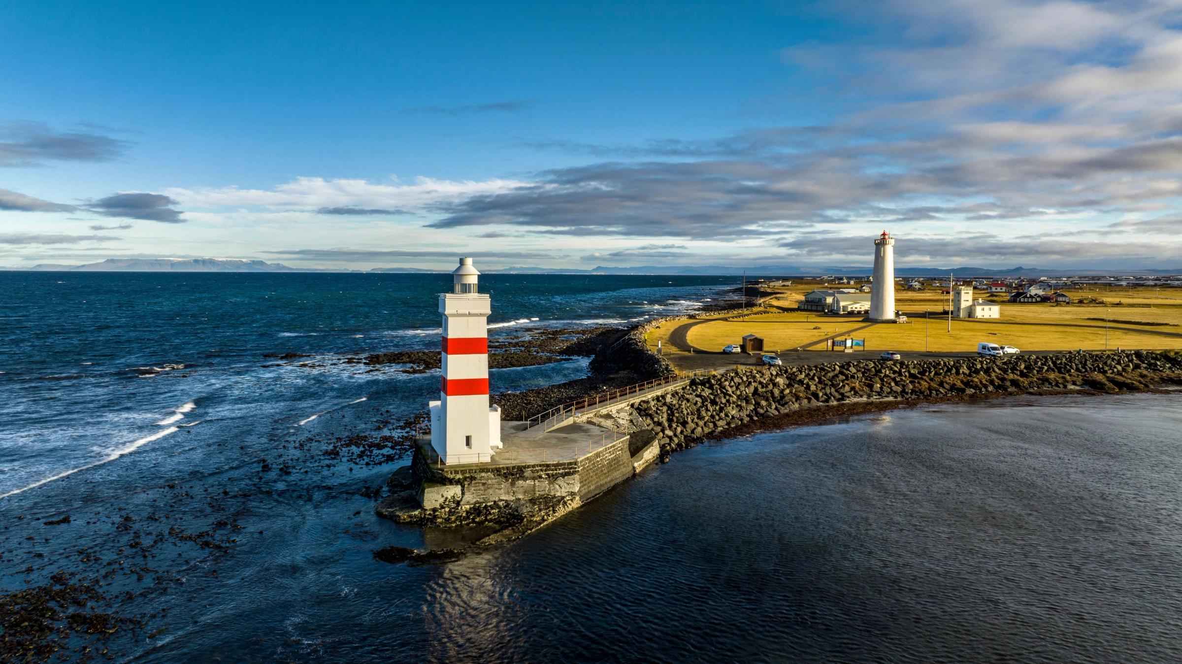 Panoramic view on Garður Old Lighthouse, surrounded by the ocean