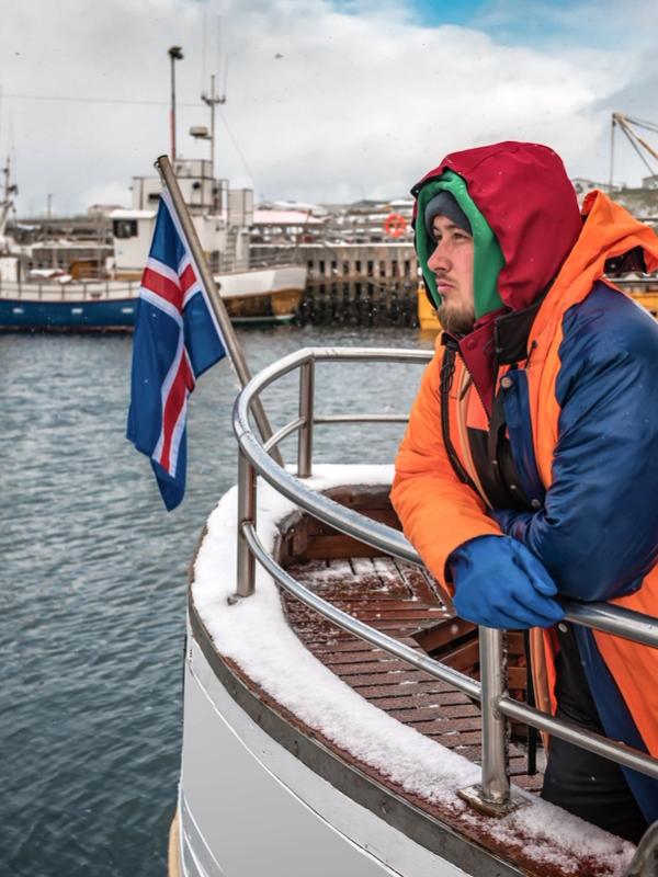 Professional fisherman in winter Iceland port photo of a fisherman particularly well covered, on his Icelandic boat in winter