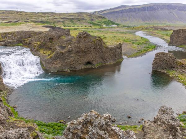 there is a waterfall in the middle of a river .