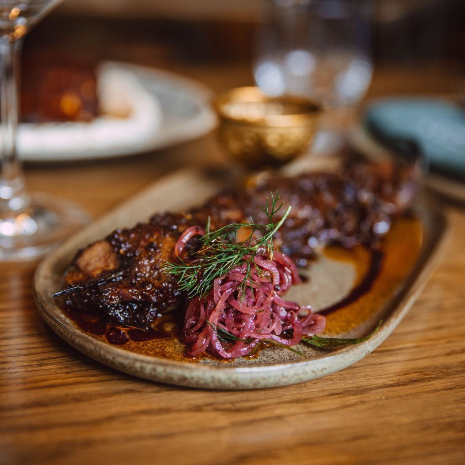 a close up of a plate of food on a wooden table .