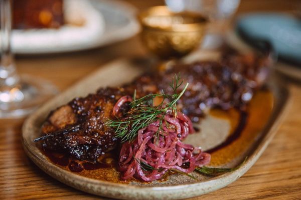 a close up of a plate of food on a wooden table .