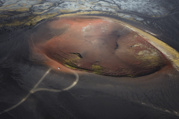 Volcanic scenery 4x4 suv rental car driving on volcanic mountain in iceland
